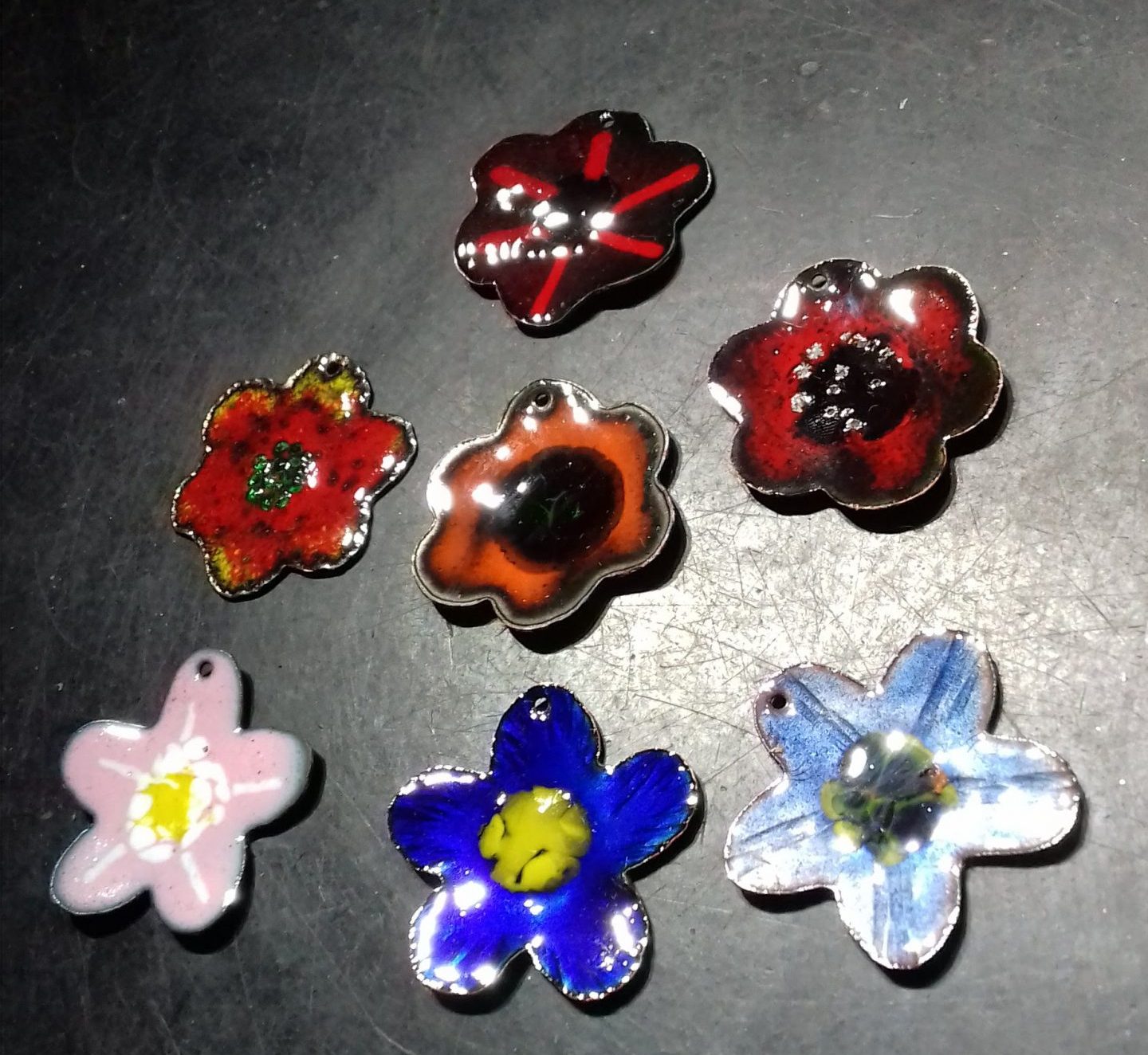 enamelled copper flower pendants just out of the kiln